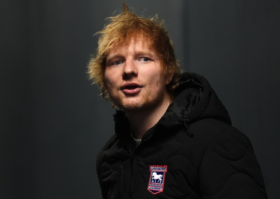 Ed Sheeran wearing an Ipswich Town jacket.