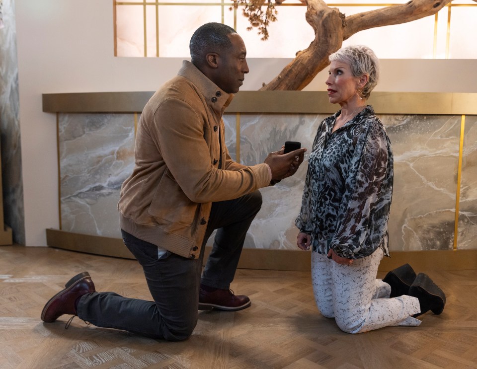 A man proposing to a woman in a hotel.