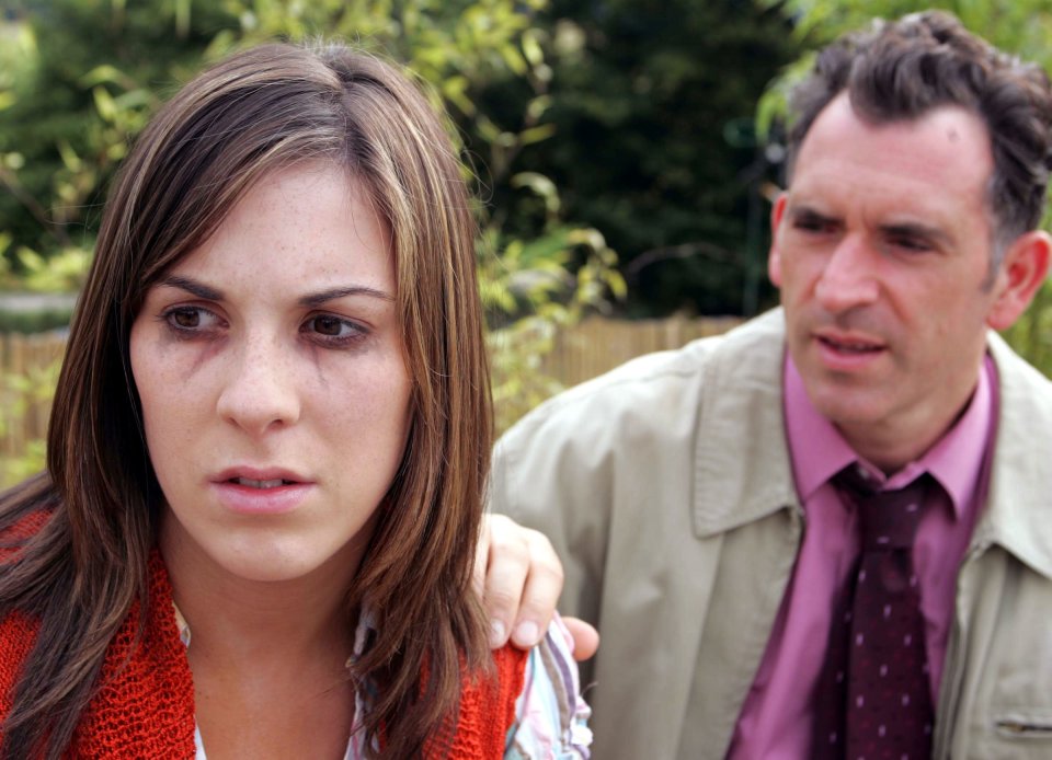 A worried young woman confides in a man.