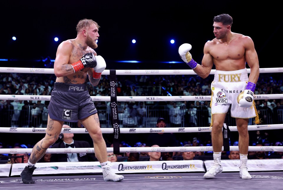 Jake Paul and Tommy Fury facing each other in a boxing ring.