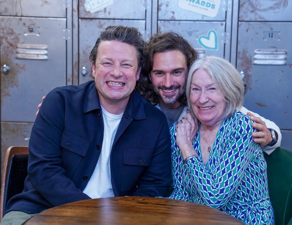 Jamie Oliver, Joe Wicks, and another woman at an awards ceremony.