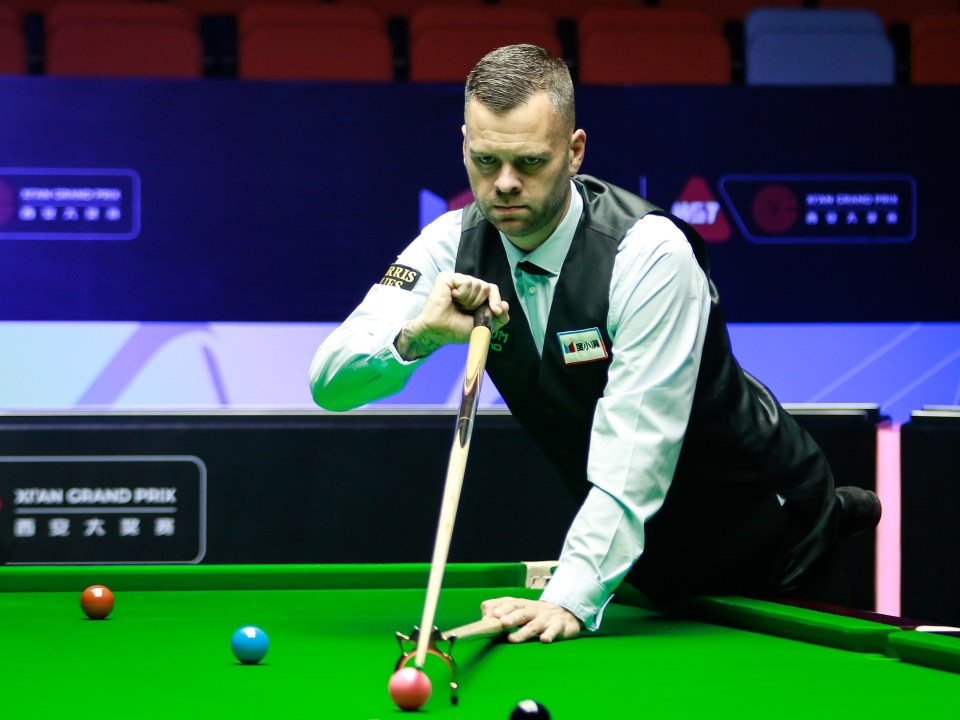 Mark Allen of England playing snooker.