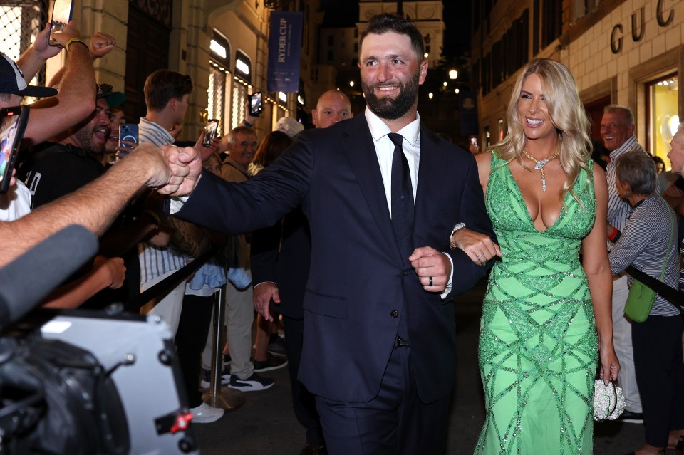 Jon Rahm and his wife Kelley Cahill walking through fans at the Ryder Cup.