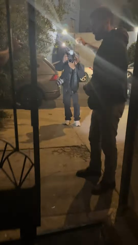 Paparazzi photographing Justin Bieber at night.