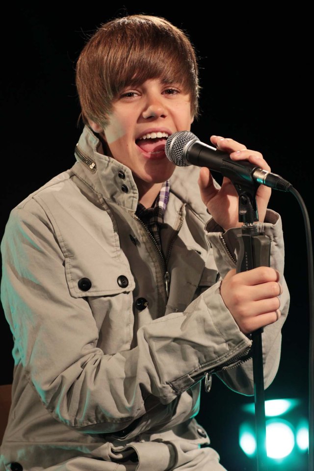 Justin Bieber singing into a microphone.