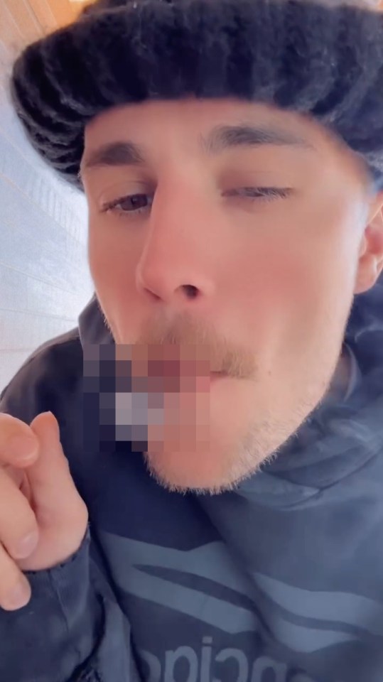 Close-up of Justin Bieber smoking.