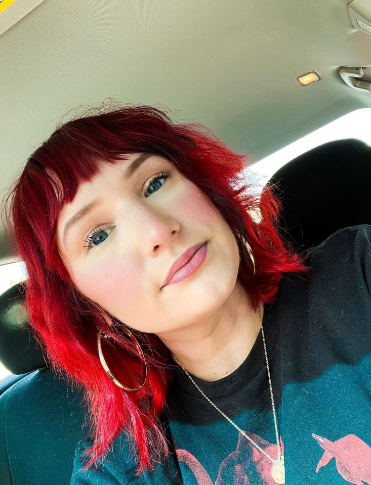 Close-up selfie of a woman with bright red hair.