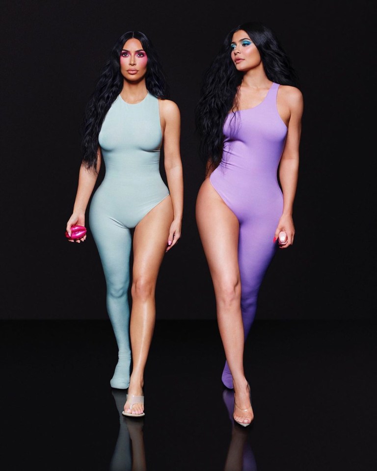 Kim Kardashian and Kylie Jenner in matching bodysuits promoting a new fragrance.