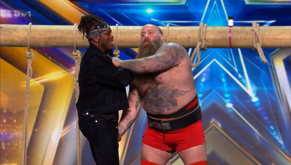 Two men competing in a tug-of-war.