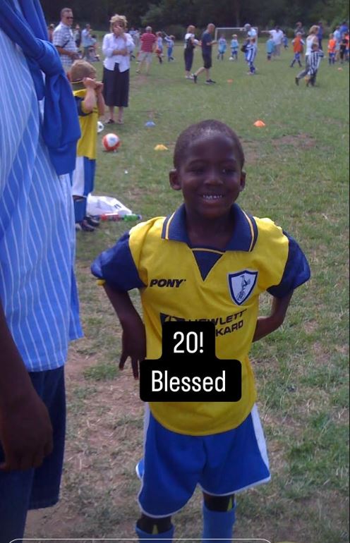 Young boy in a soccer uniform celebrating a birthday.