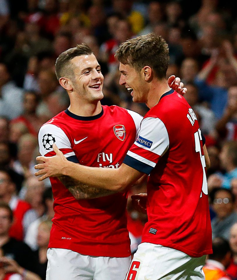 Arsenal's Ramsey and Wilshere celebrating a goal.