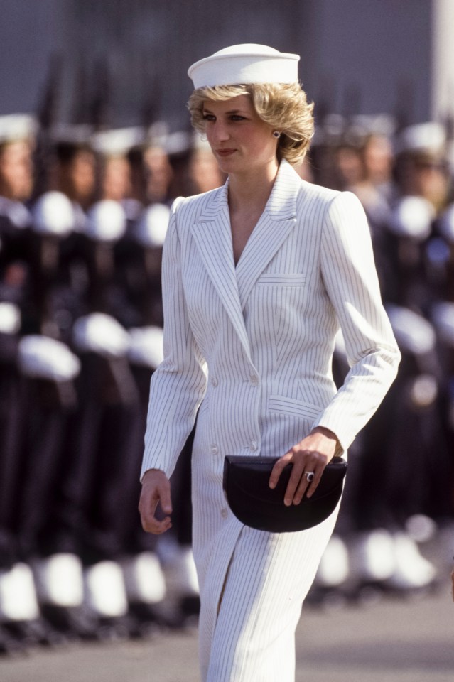 Princess Diana in a white pinstripe suit and hat.