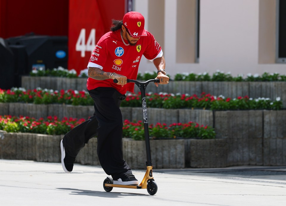 Lewis Hamilton riding a scooter.