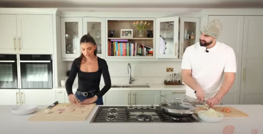 Two people cooking in a kitchen.