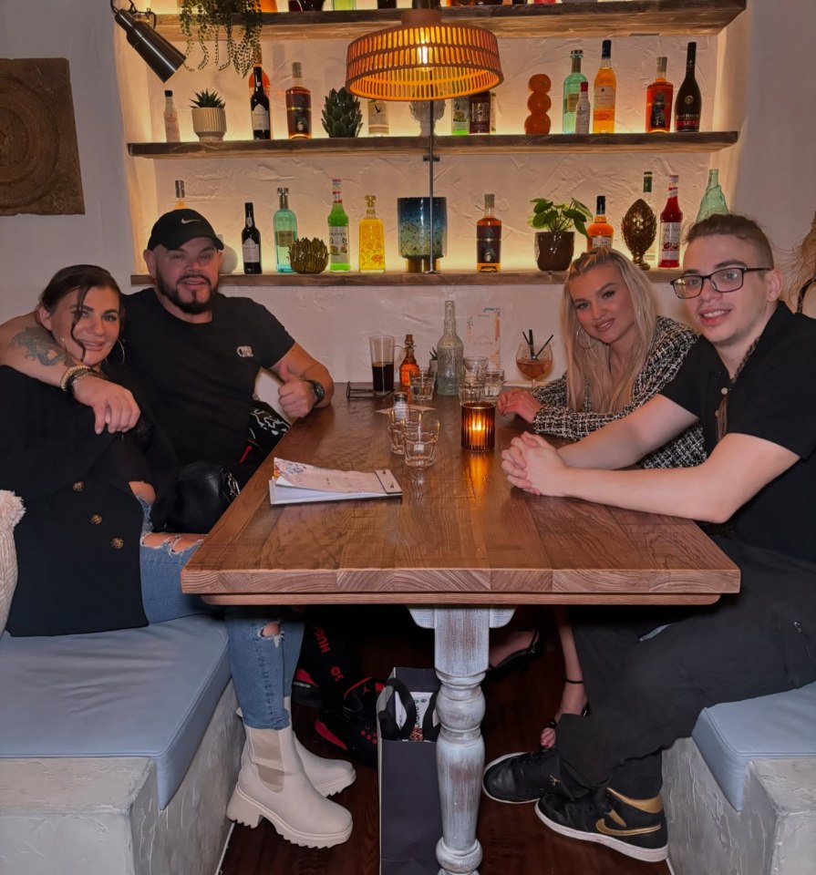 Four people sitting at a restaurant table.