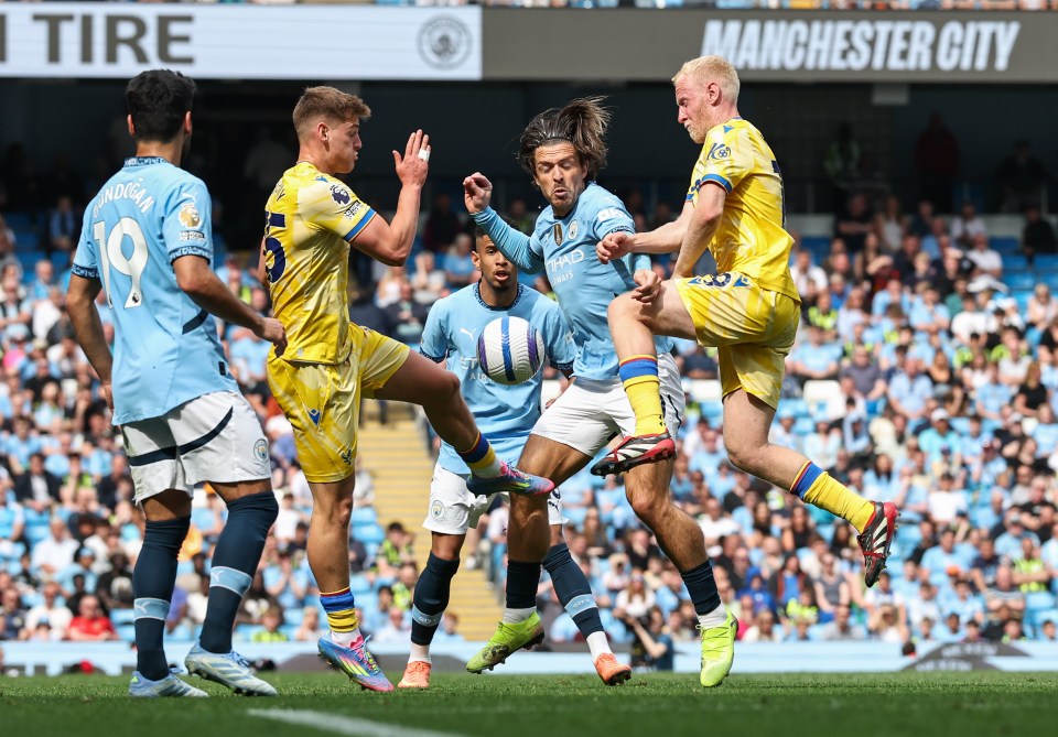 Manchester City's Jack Grealish battling for the ball during a Premier League match.