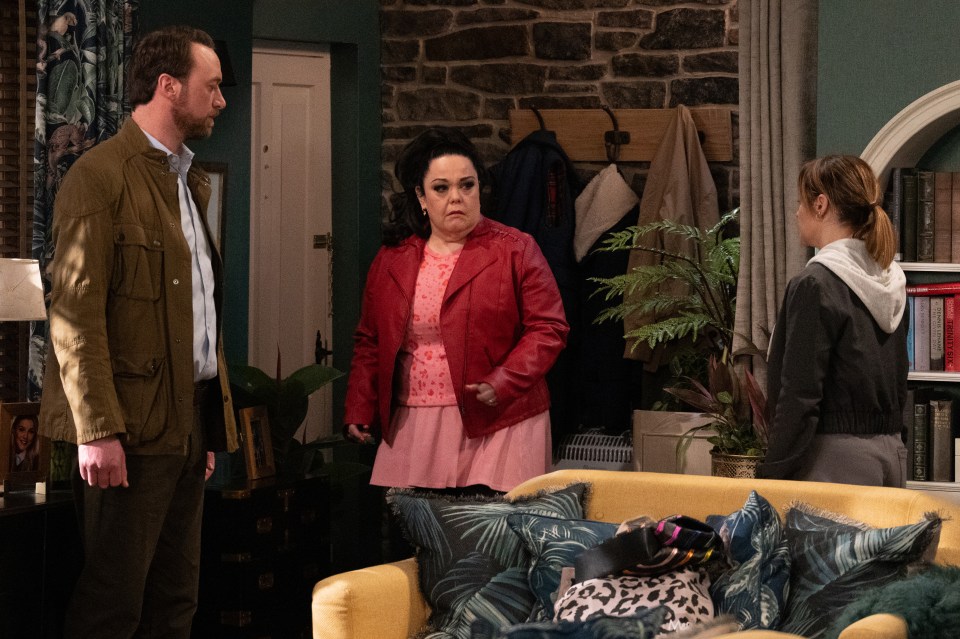 Scene from Emmerdale showing three characters in a tense confrontation.