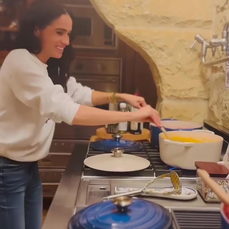 Meghan Markle cooking in a kitchen.