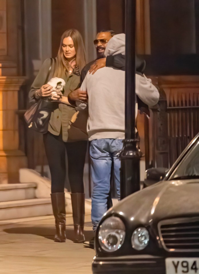 Mickey Rourke leaving a London hotel with a woman and another man.
