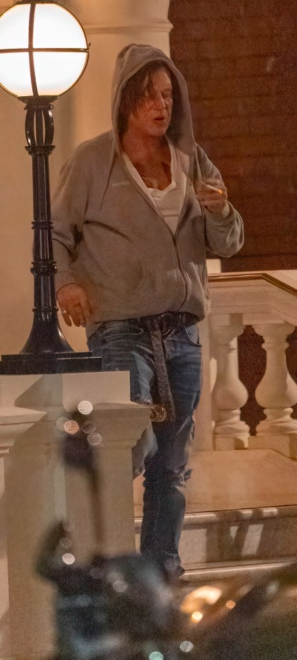 Mickey Rourke smoking a cigarette outside a London hotel.