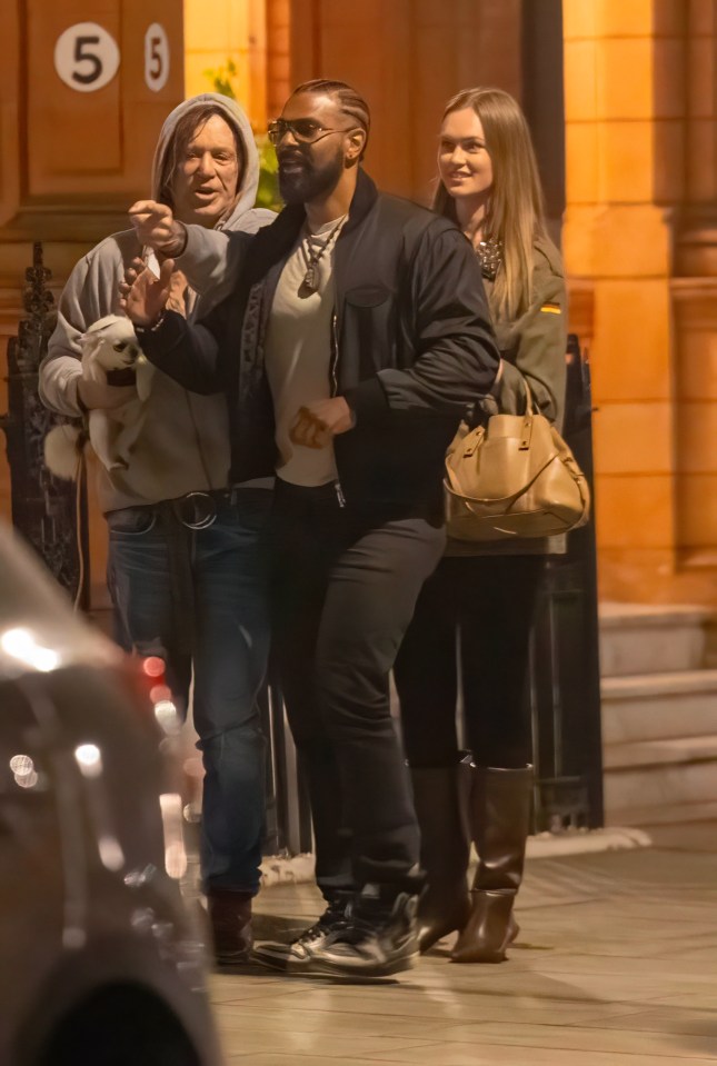 Mickey Rourke leaving a London hotel with a man and woman.