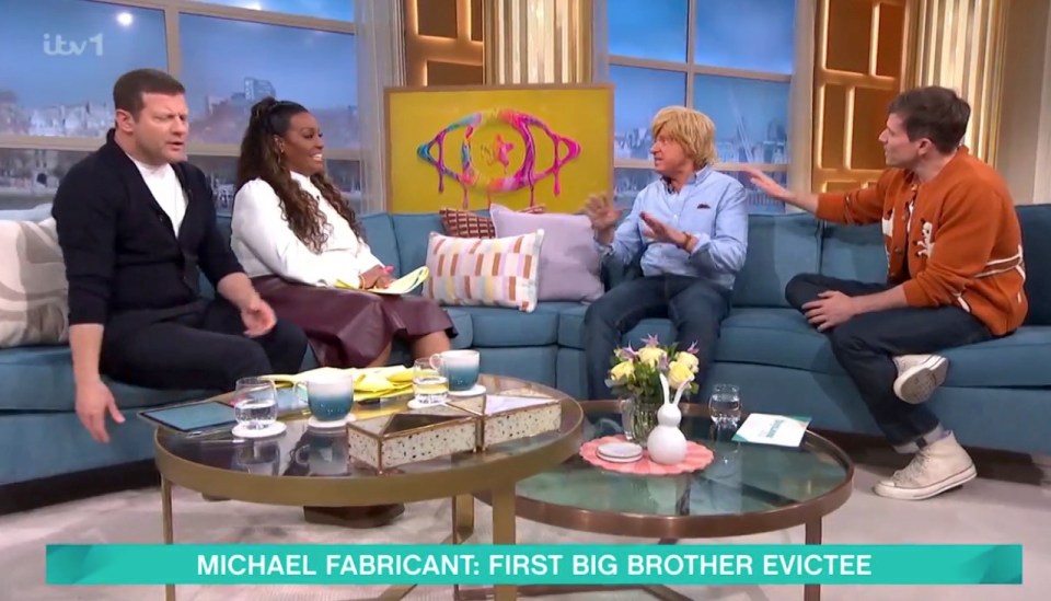 Four people sitting on a teal couch discussing Michael Fabricant, the first Big Brother evictee.