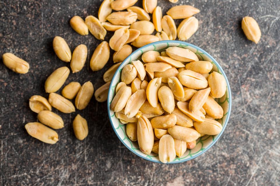 Bowl of salty roasted peanuts.