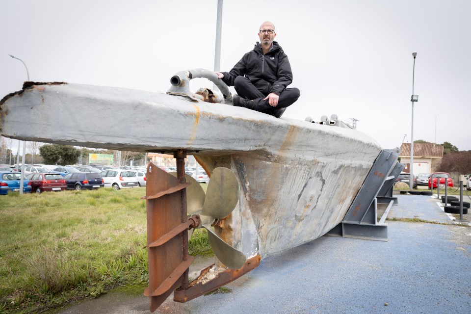 Man sitting on a seized narco-submarine.