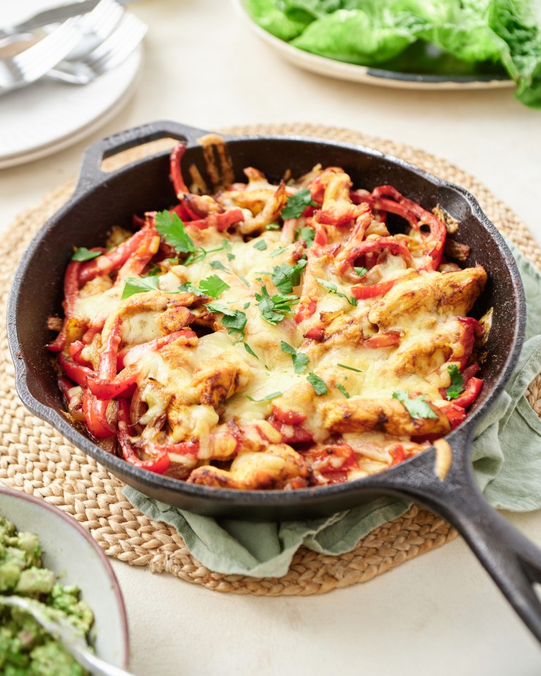 Chicken and peppers skillet dish with melted cheese.