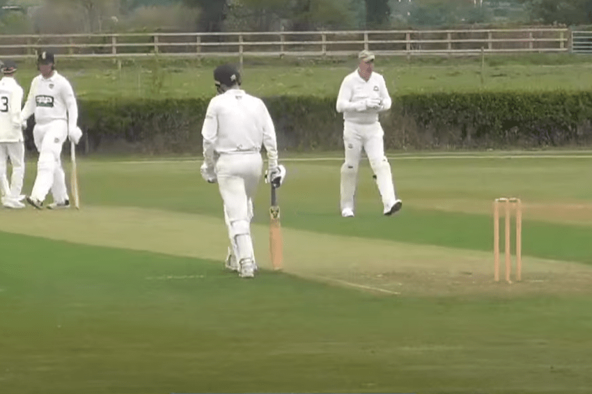 Cricket players on a field.