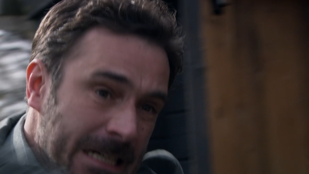 Close-up of a man reacting to being hit on the head.