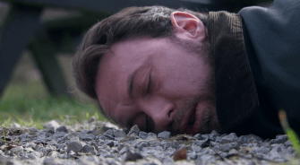 A man lying unconscious on the ground.