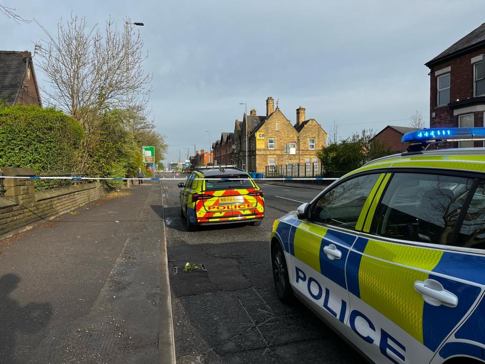 Police cars at a road closure following a serious car accident.