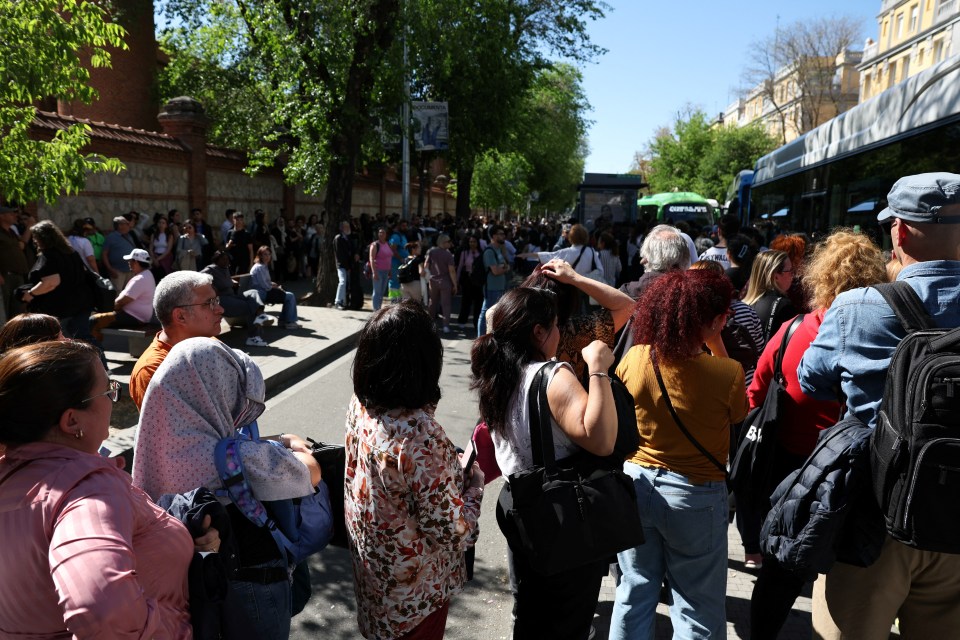 People queueing for a bus during a power outage in Madrid.