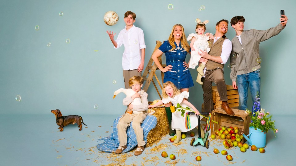 Family portrait with children, dog, and farm animals.