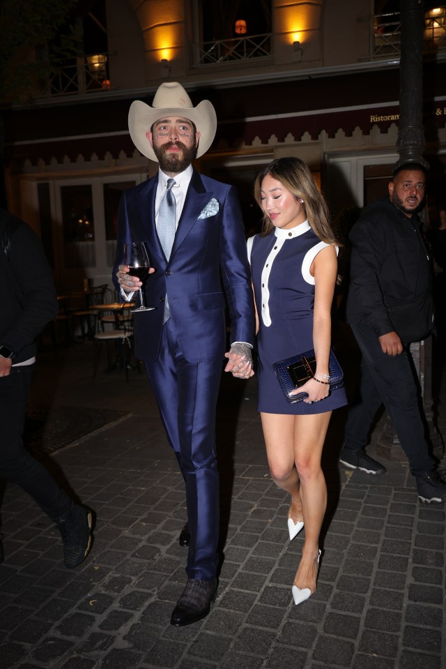 Post Malone and Christy Lee holding hands after dinner.