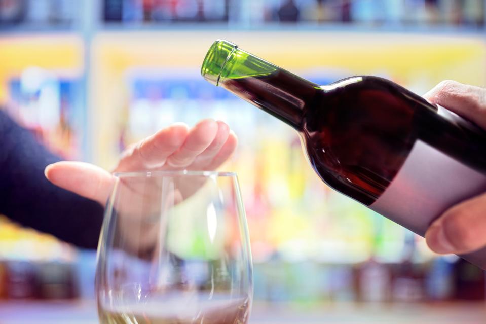 Woman's hand rejecting alcohol.