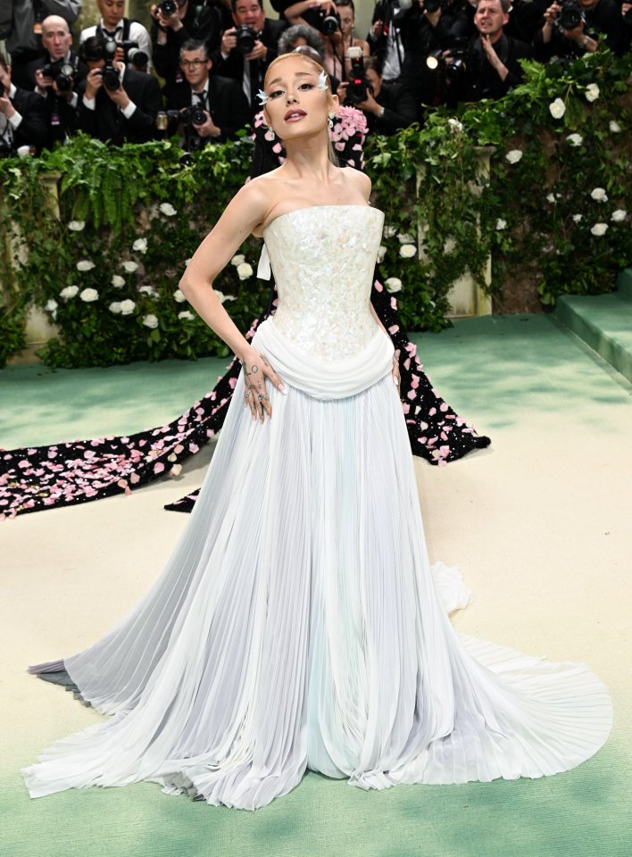 Ariana Grande at the Met Gala in a white pleated gown.