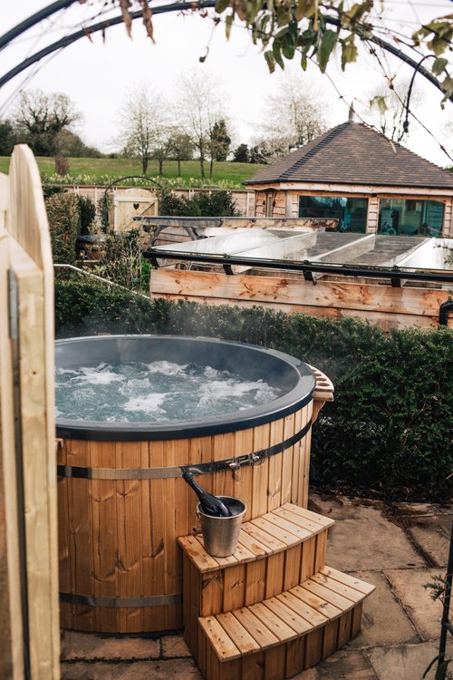 Hot tub with champagne on wooden steps at The Manor House Hotel.