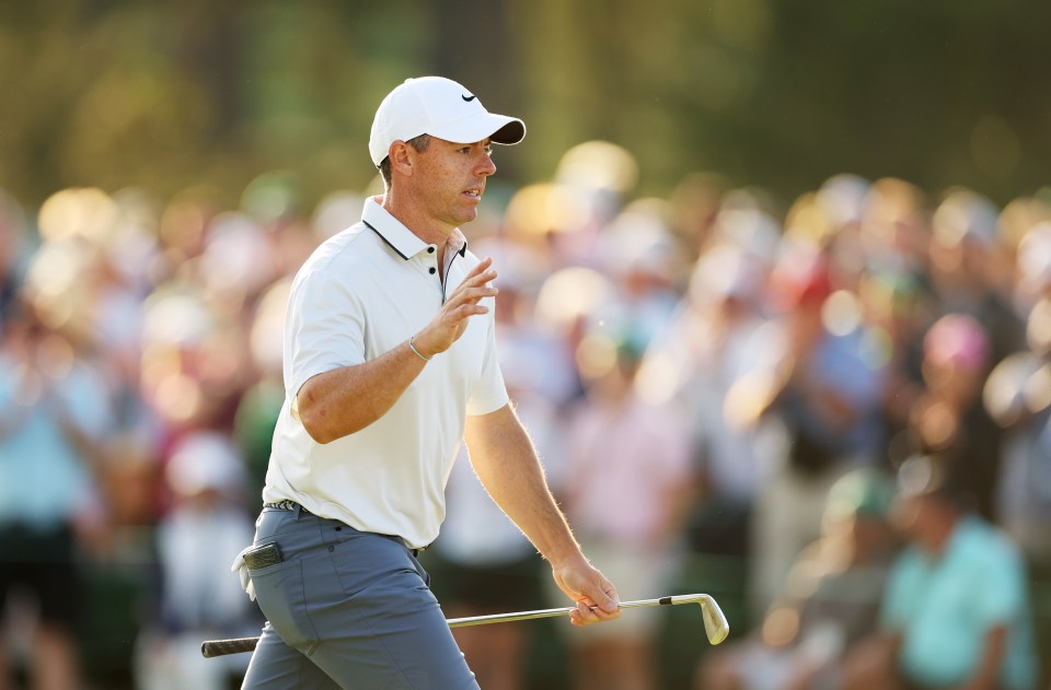 Rory McIlroy acknowledging the crowd at a golf tournament.