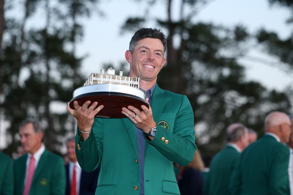Rory McIlroy holding the Masters trophy in a green jacket.