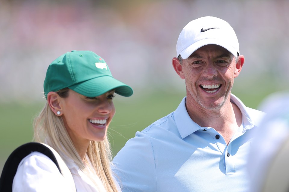 Rory McIlroy and his wife Erica Stoll smiling.
