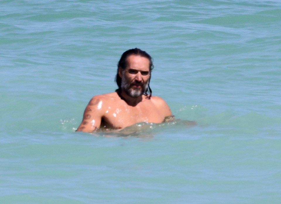 Russell Brand in the ocean.