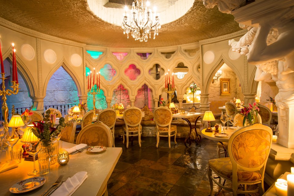 Interior view of a restaurant with ornate decor and candlelit tables.