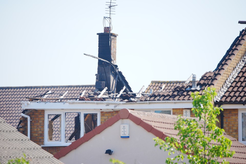 House with roof damage from explosion.