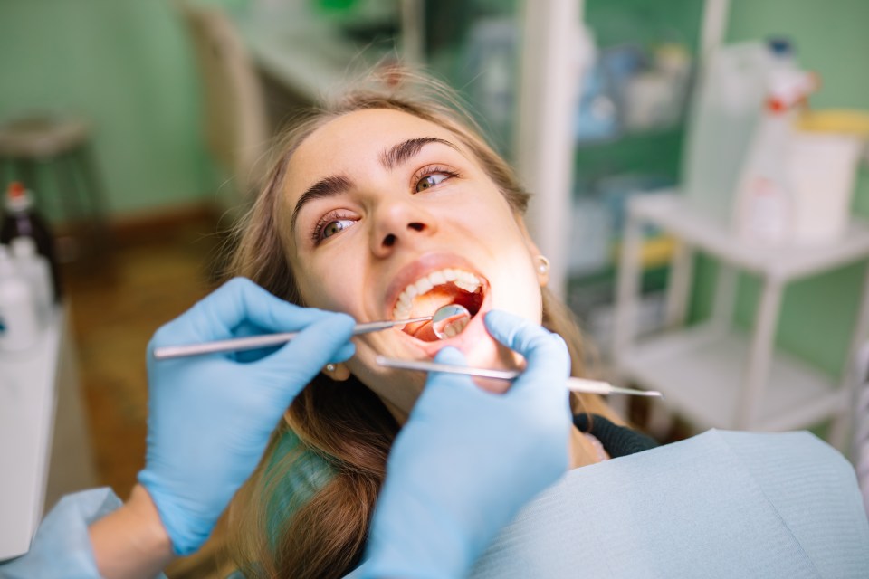 Dentist examining a patient's teeth.