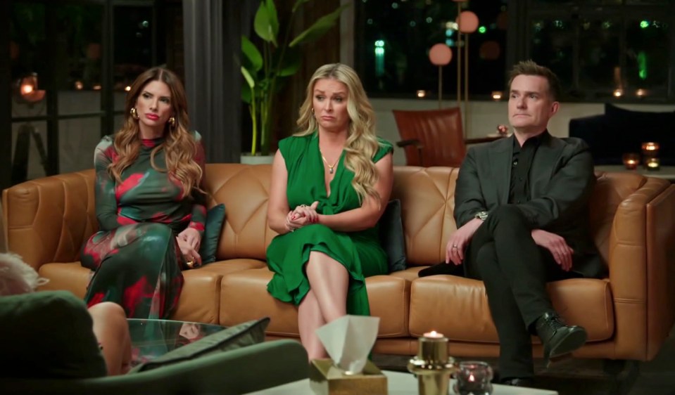 Three people sitting on a couch during a tense scene from *Married at First Sight Australia*.