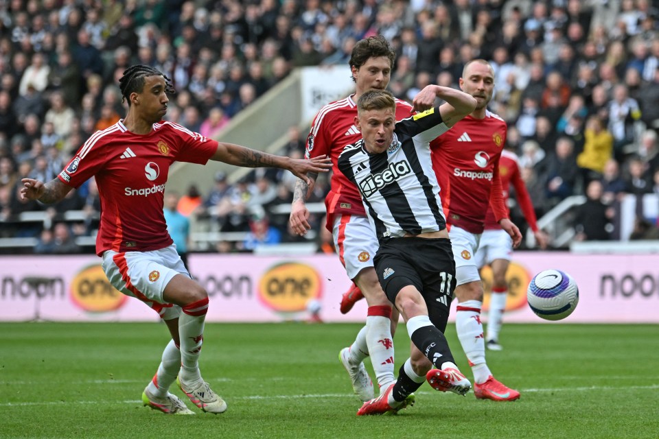 Harvey Barnes scoring a goal during a Newcastle United vs Manchester United soccer match.