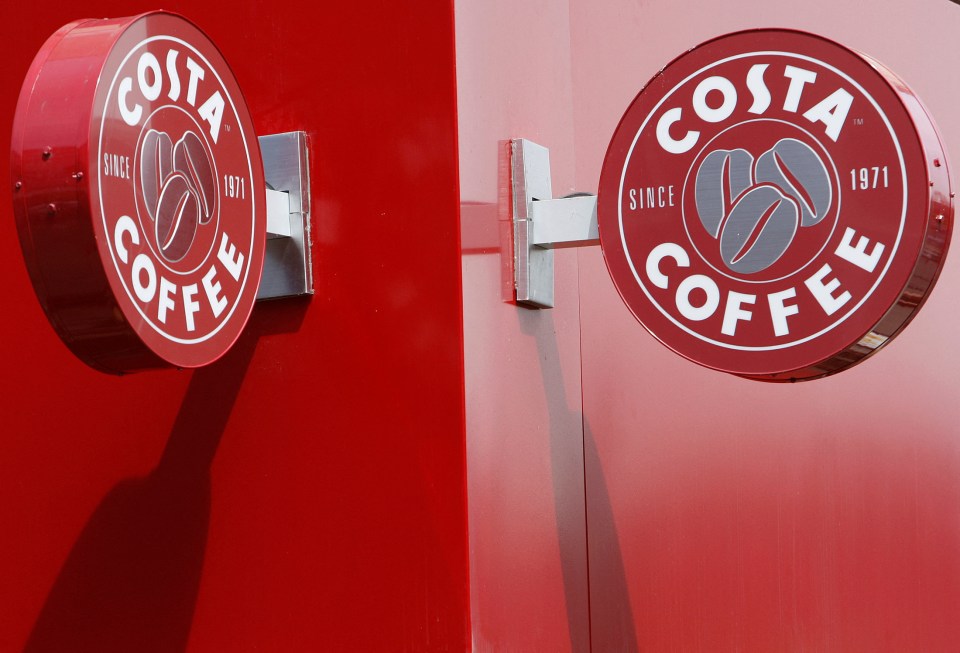 Two Costa Coffee signs on a red building.