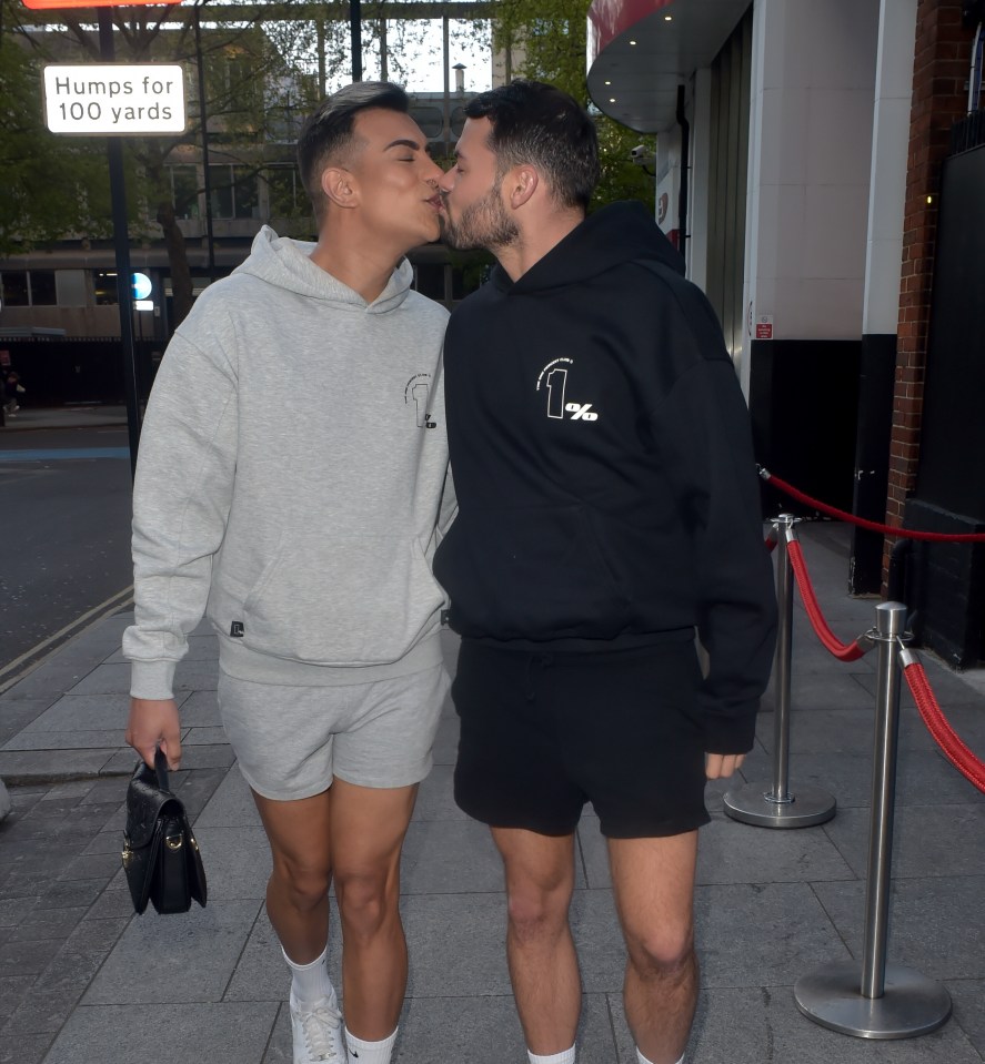 Two men kissing outside Ministry of Sound.